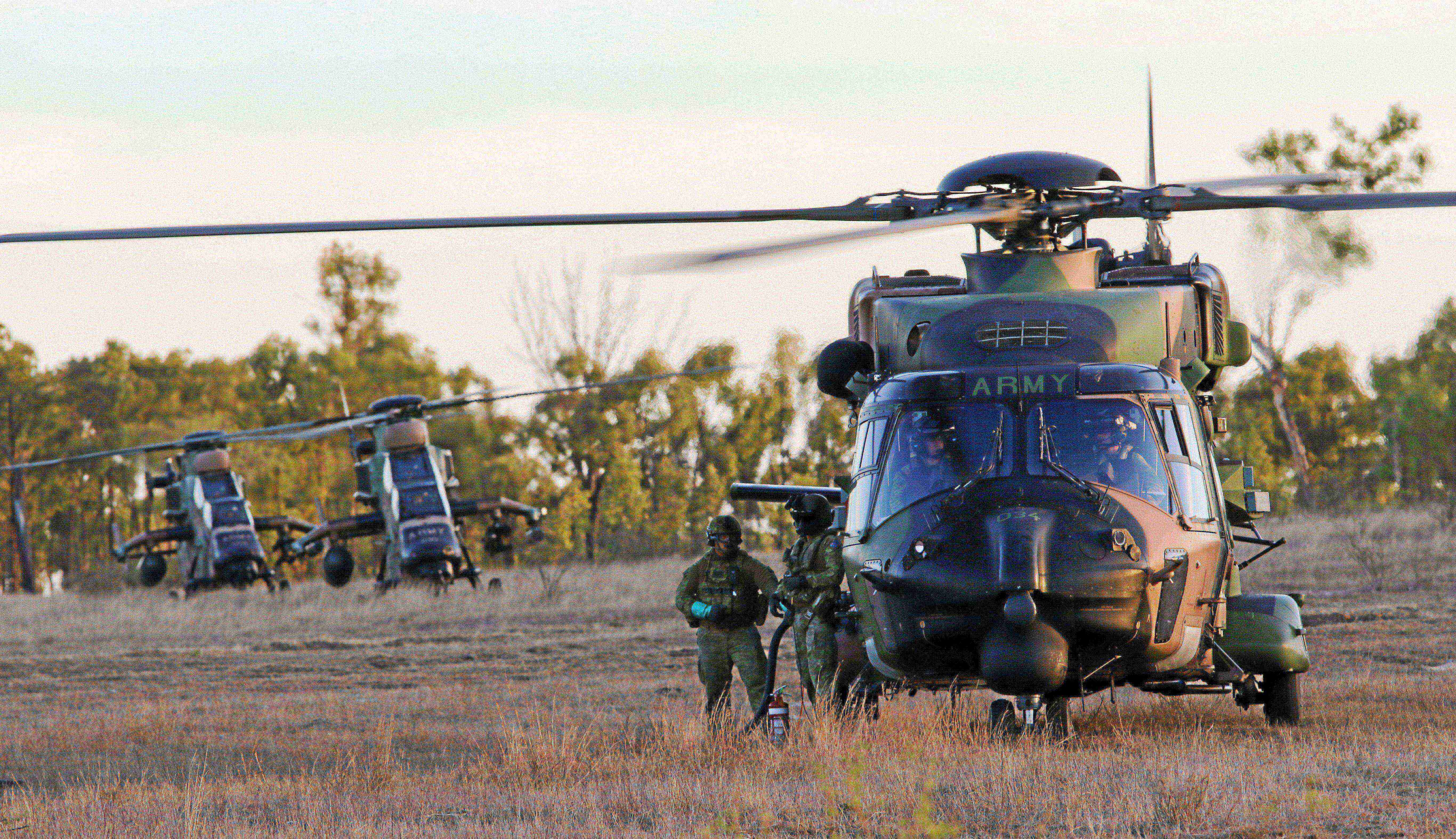 Australian Army soldiers work with an MRH90 Taipan helicopter 