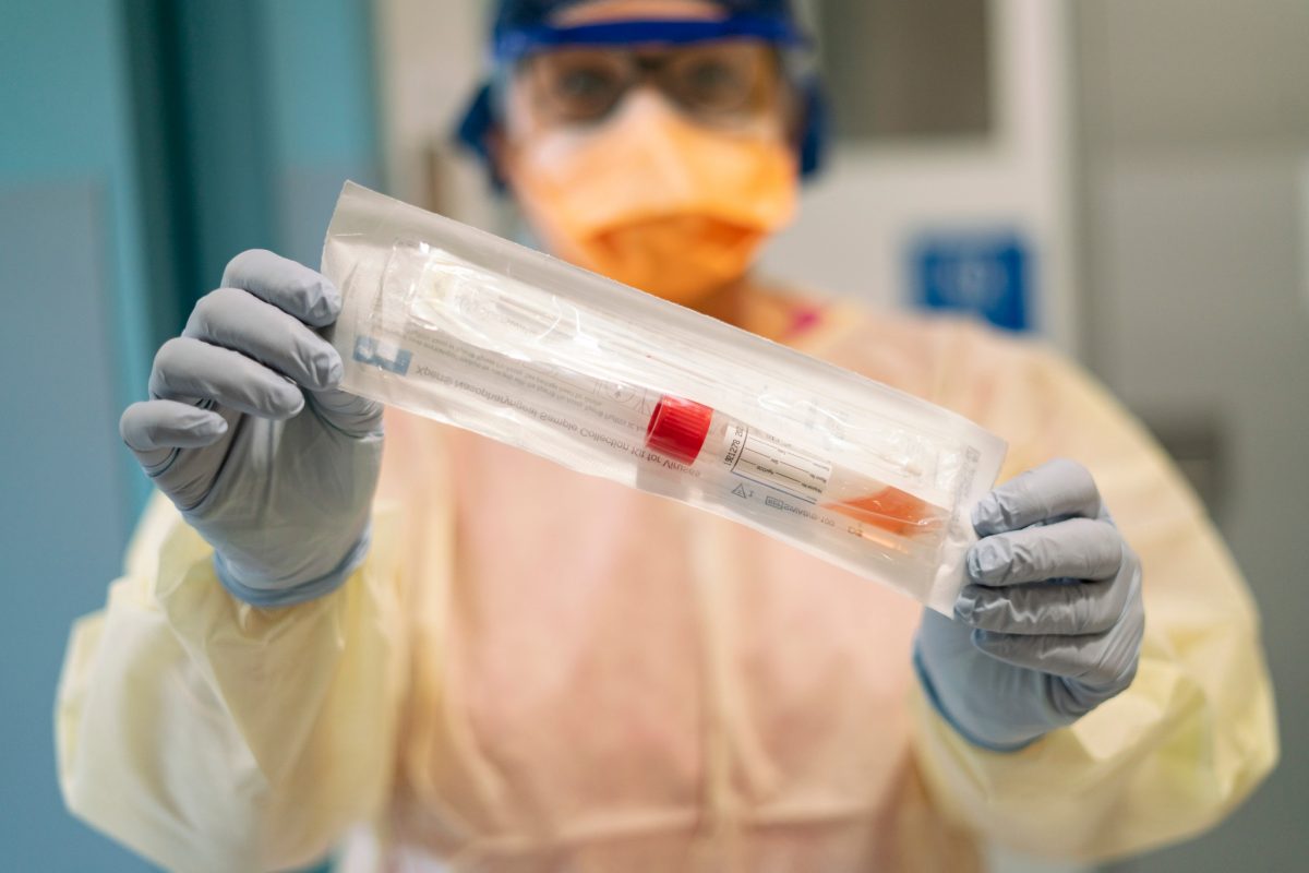 nurse holding a covid test