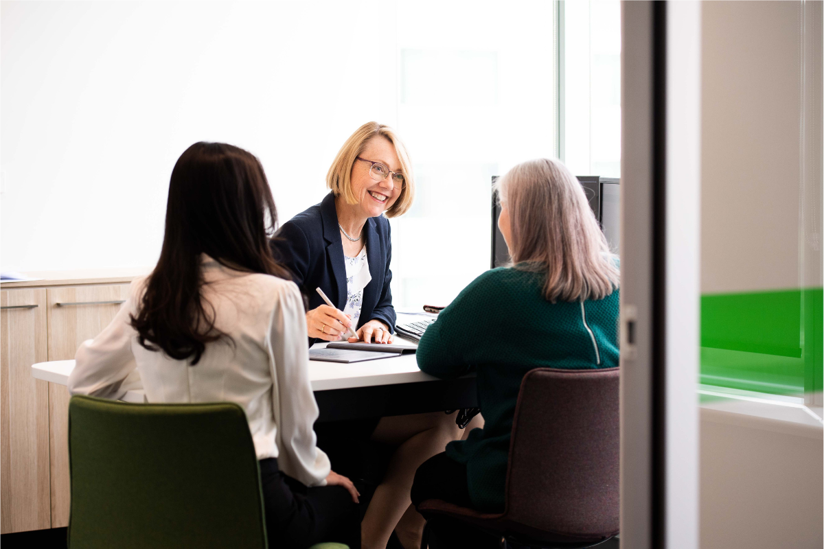 three people sitting at a desk