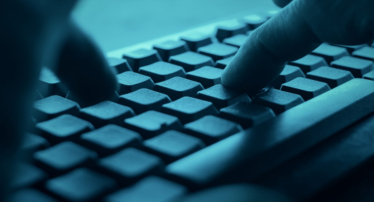 Hands typing on desktop pc computer keyboard