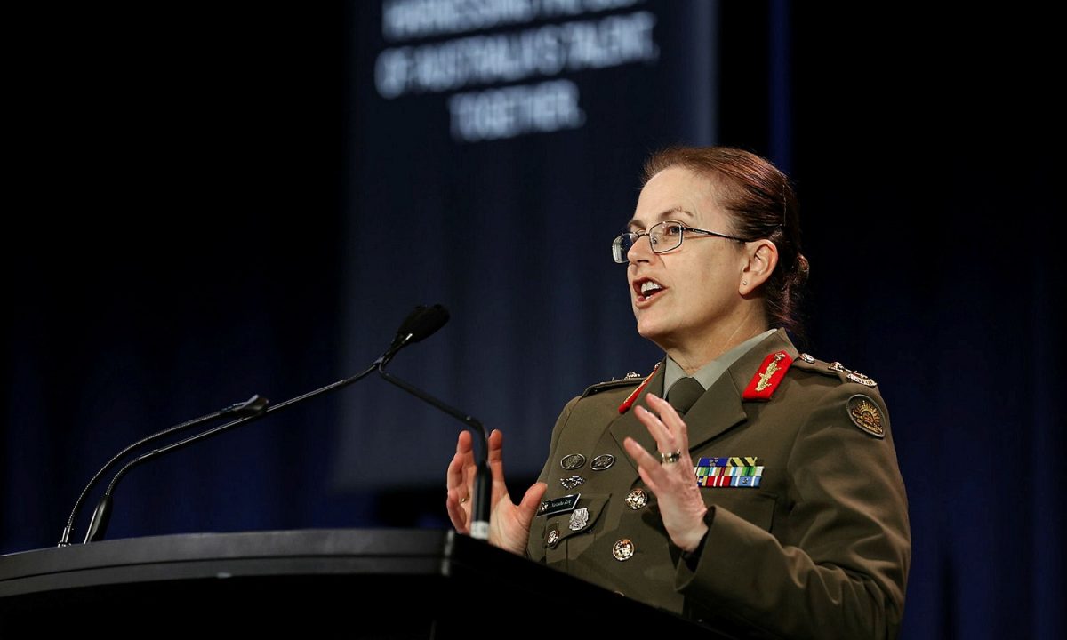 army woman speaking at podium