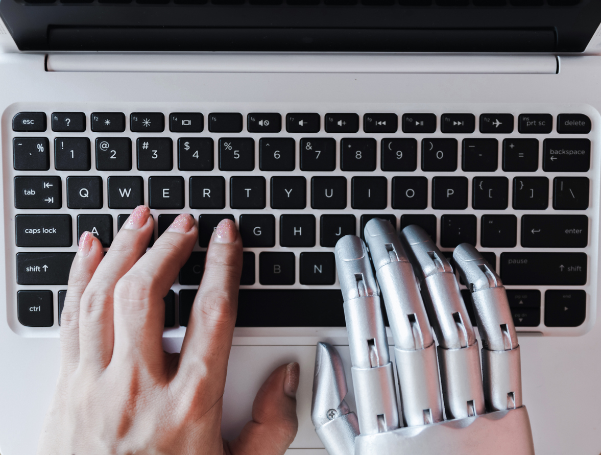 human hand and robot hand typing