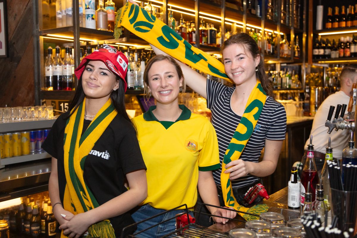 Bartenders posing for a photo in Matildas attire