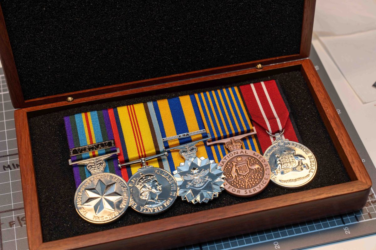 Medals lined up in a timber box