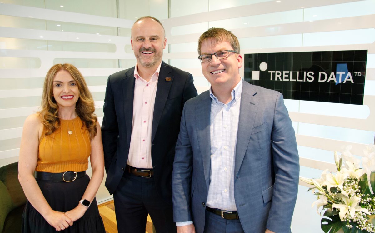 Rachel Gately, Andrew Barr and Michael Gately standing in front of a Trellis Data sign.