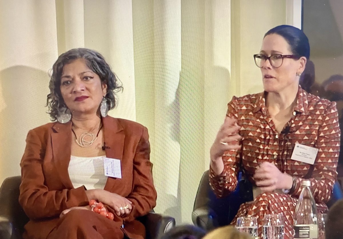 two women on stage at a conference