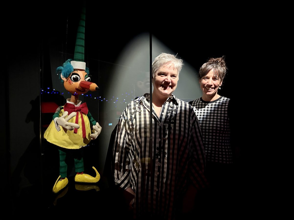 Norman Hetherington's daughter, Rebecca Hetherington, and and the National Museum of Australia's Dr Sophie Jensen with an original Mr Squiggle puppet.
