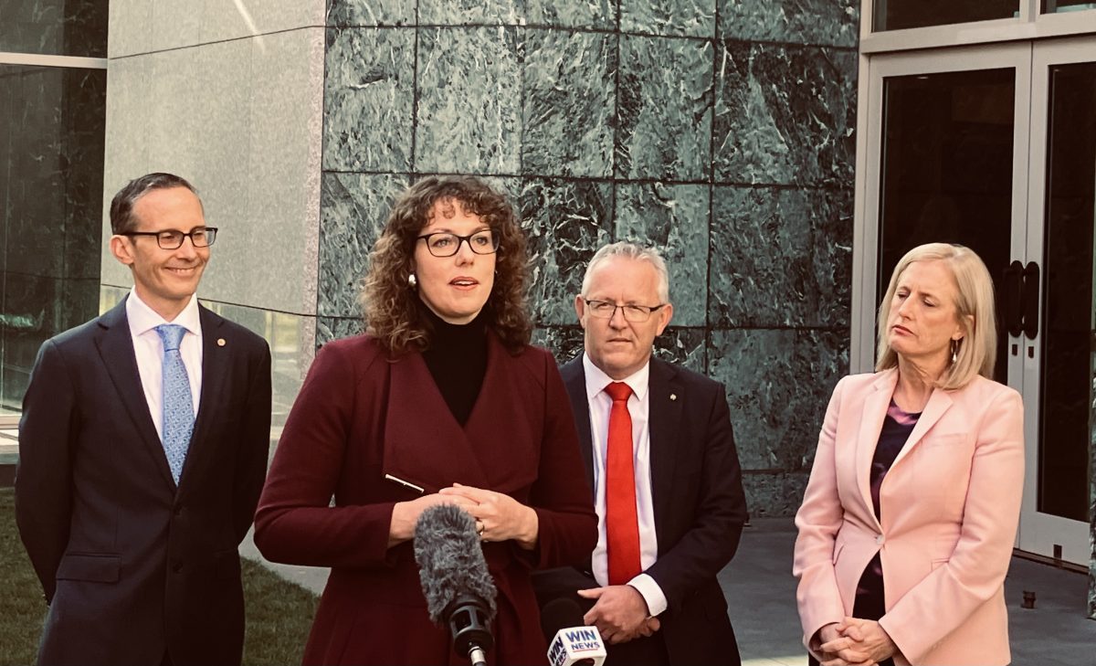 four politicians standing in a courtyard at Parliament House