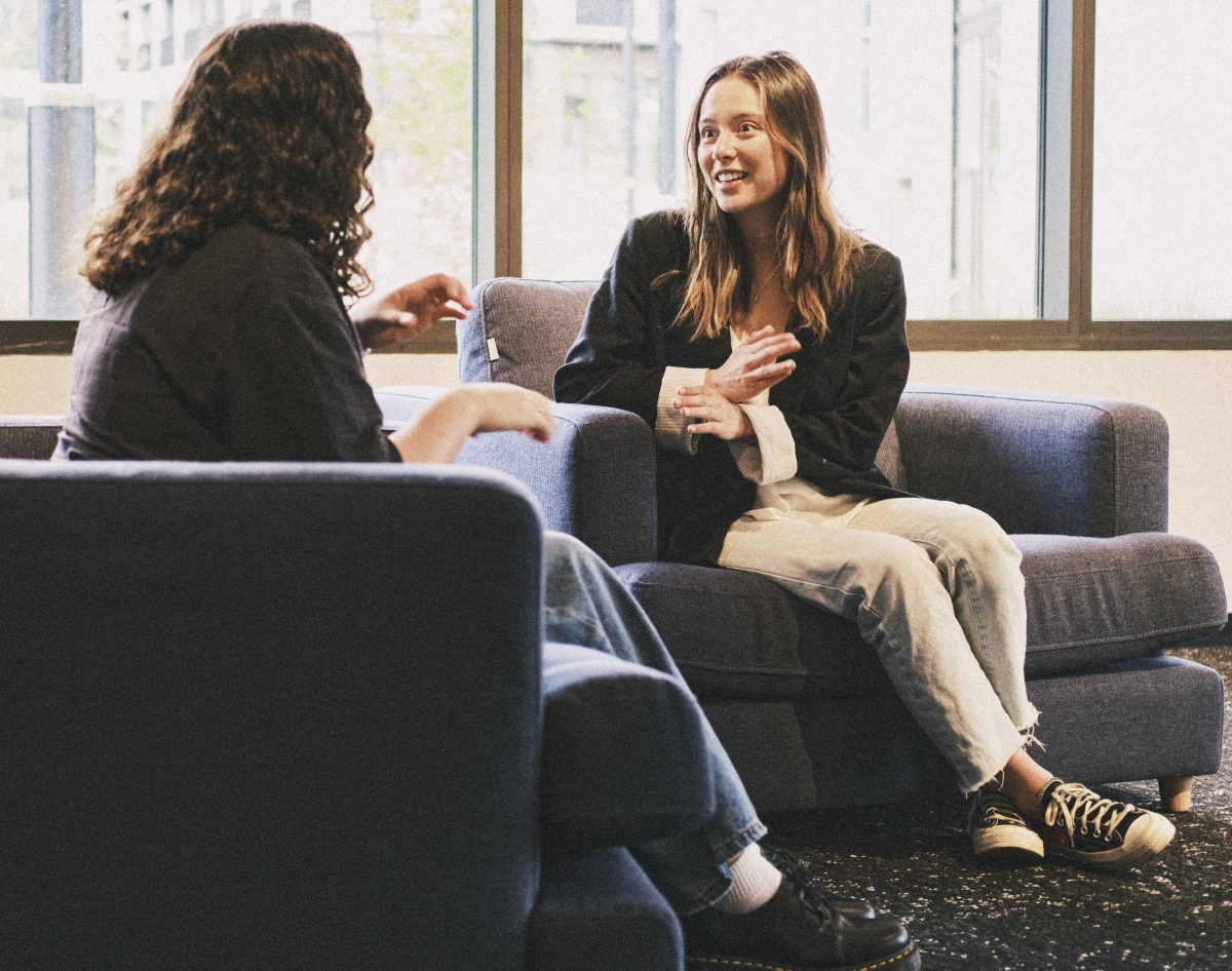 Woman signing to another woman 