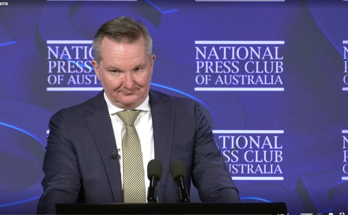 man giving a speech at lectern 