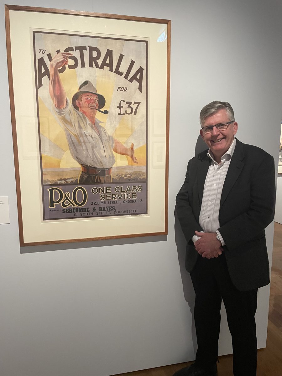 Man standing in front of poster