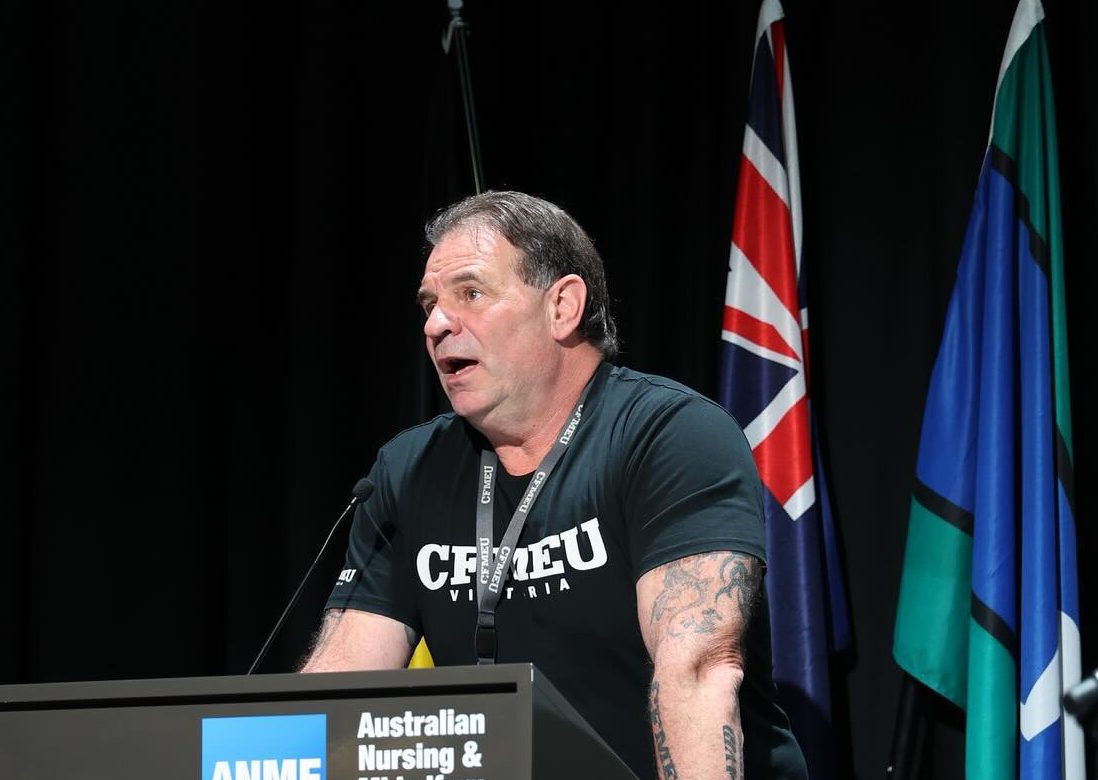 man speaking at lectern