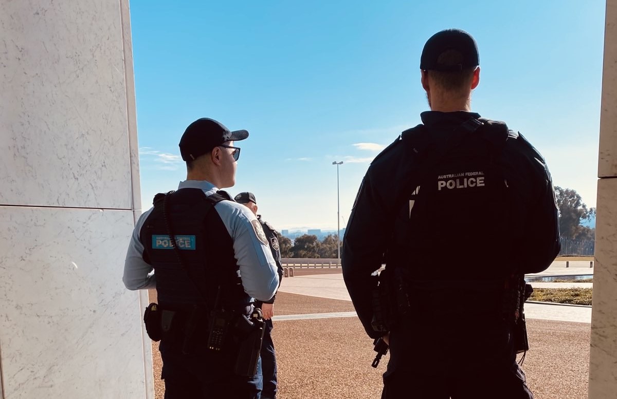 Uniformed AFP officers standing outside Parliament House.