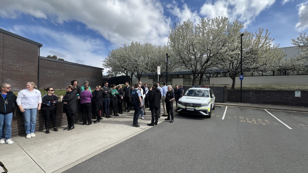 A group of AFP staff members standing around the front of the Belconnen Police station.