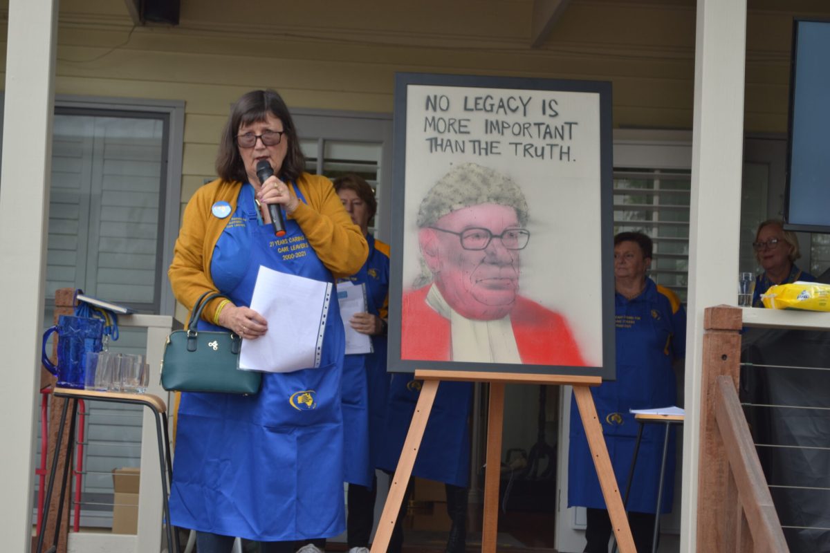 Leonie Sheedy speaking with microphone next to picture