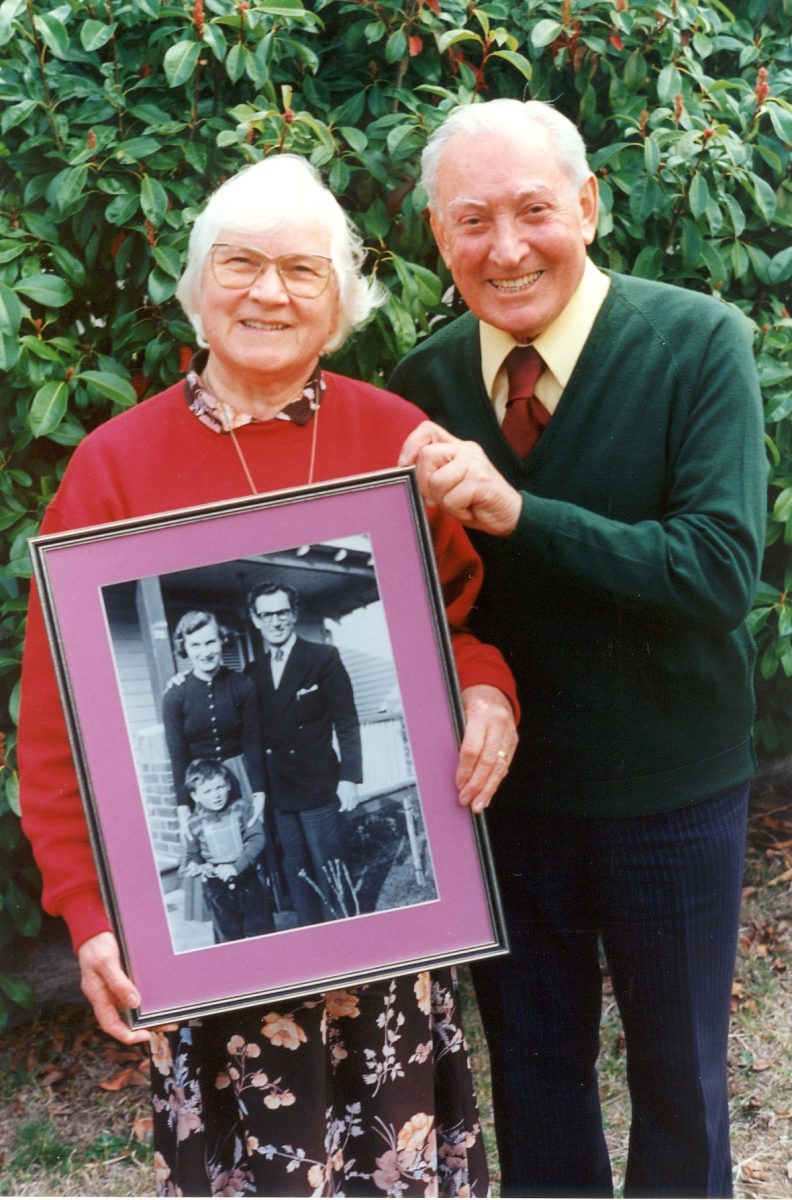 Olive and Loreto holding old photo 