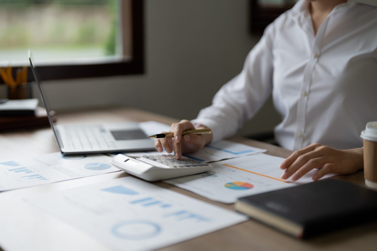 Business woman using calculator for do math finance in office, tax, accounting, statistics and analytic research concept.