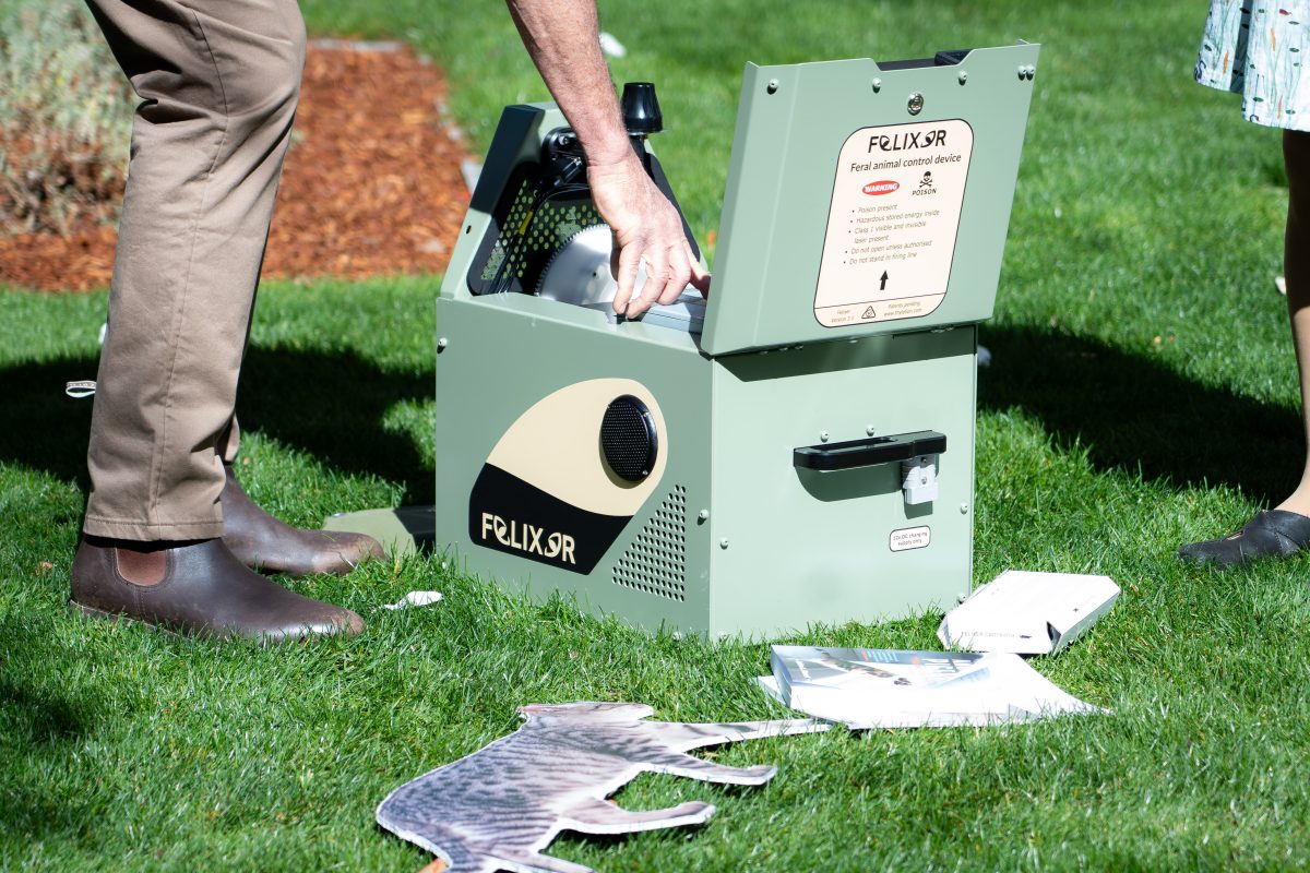 Hi-tech cat trap box being opened by operator.