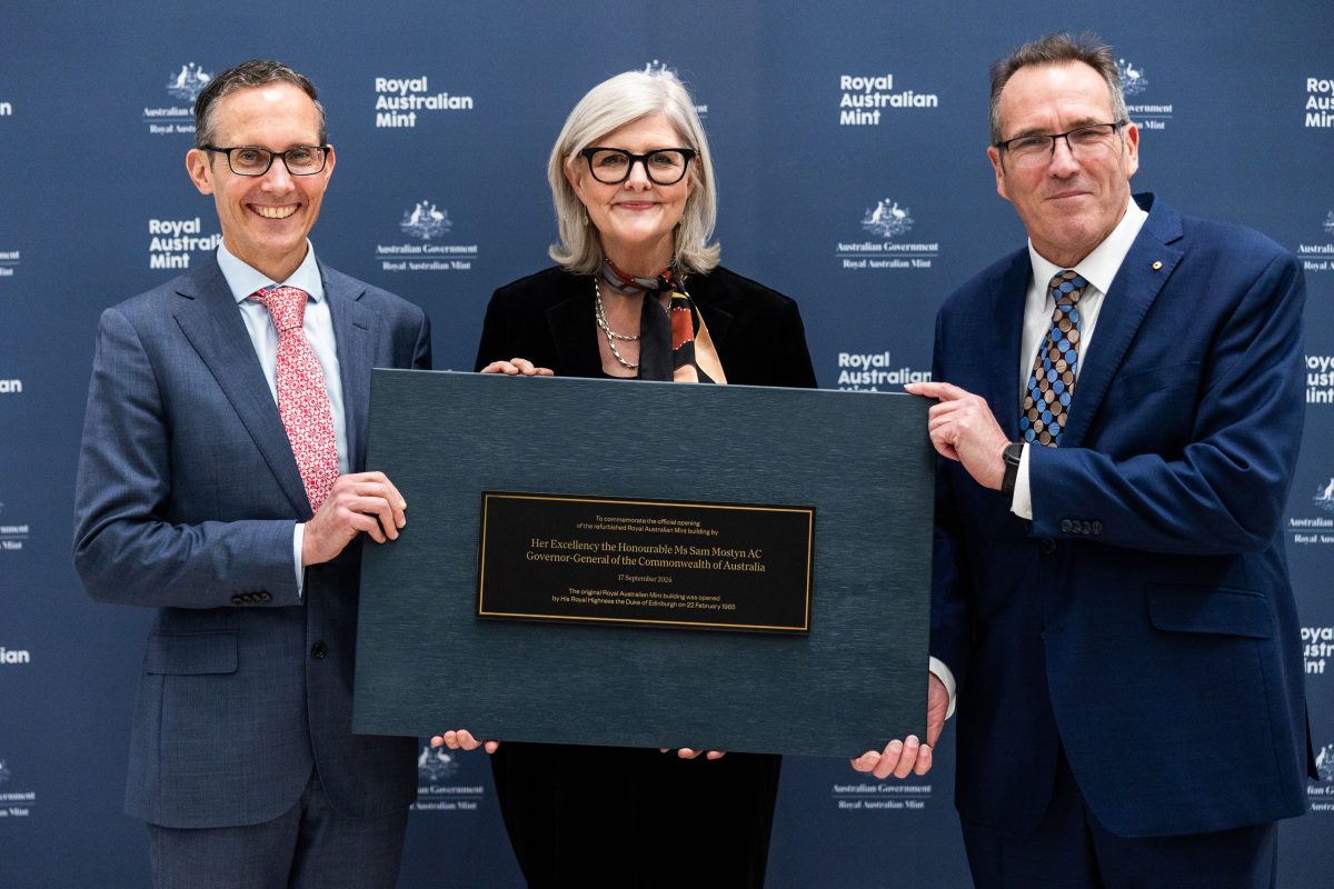 People holding plaque