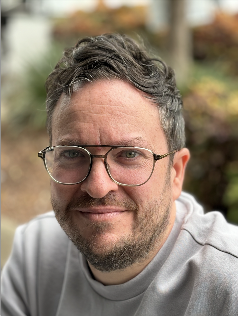 headshot of man wearing glasses