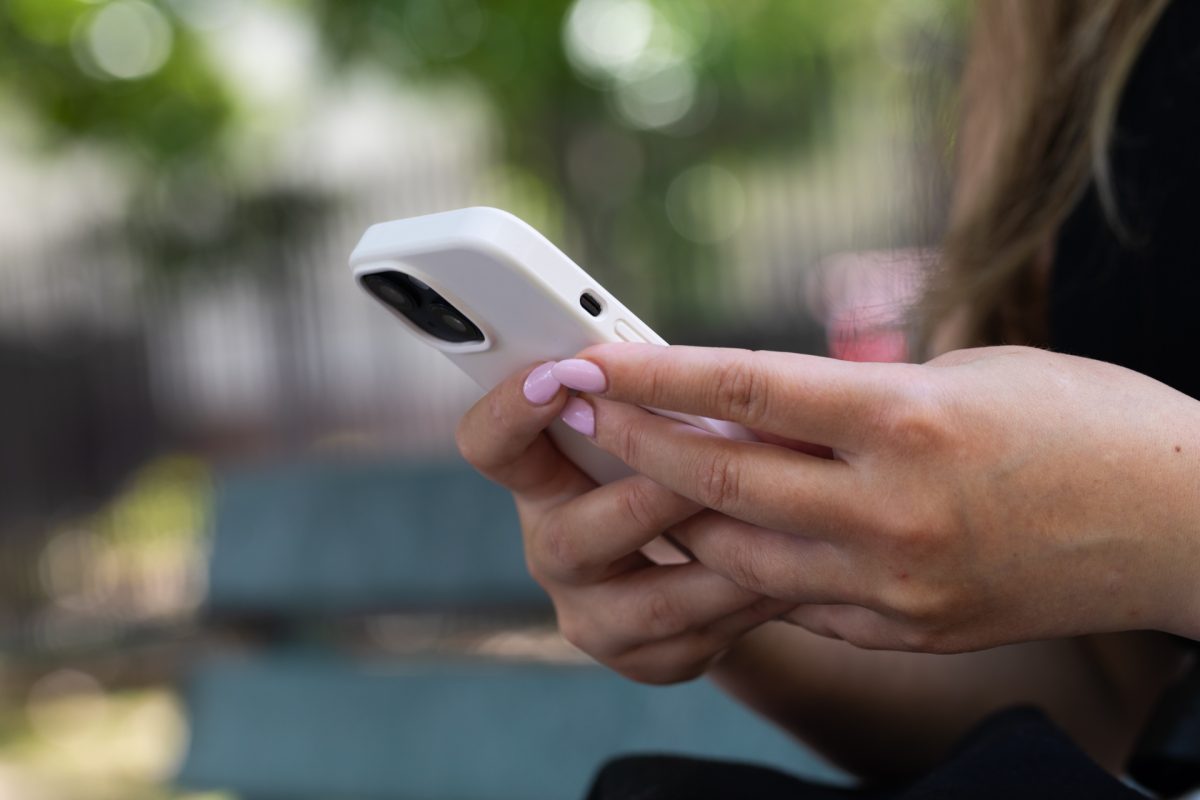 Hands holding mobile phone