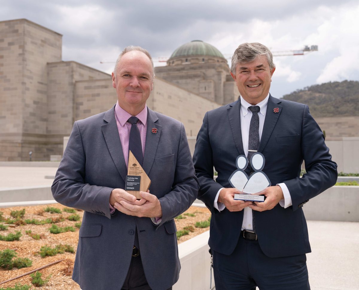 two men with awards in front of the War Memorial