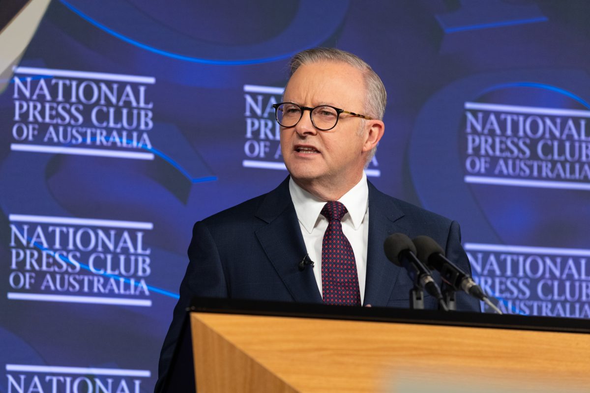 man speaking from a lectern