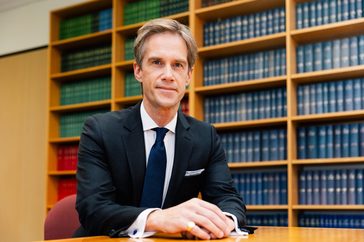 Professor Brent Jackson sits at a desk