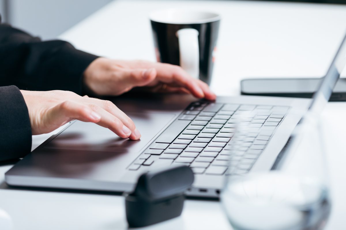 Hands using laptop computer