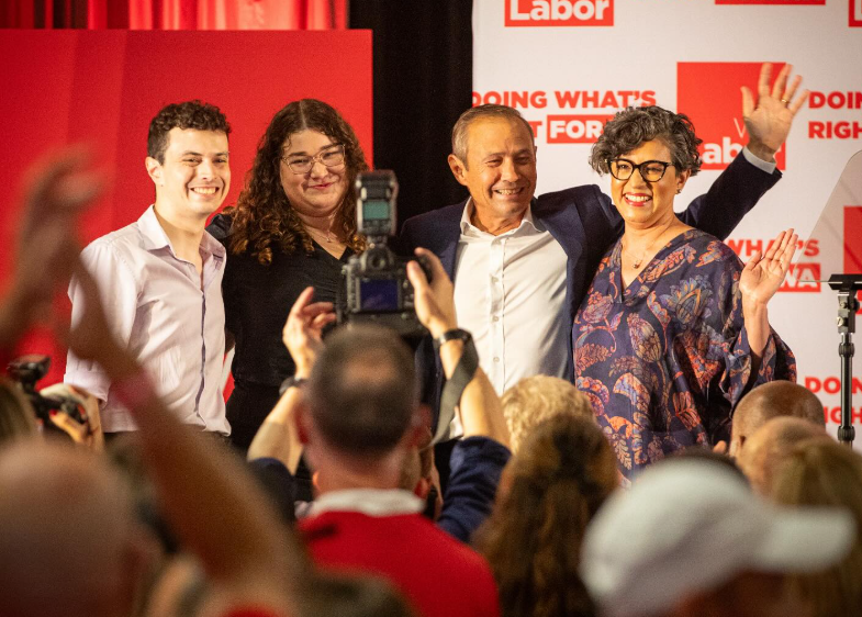 Roger Cook and his family facing a crowd celebrating