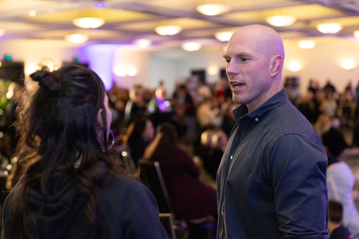 Bald man in conversation with woman.