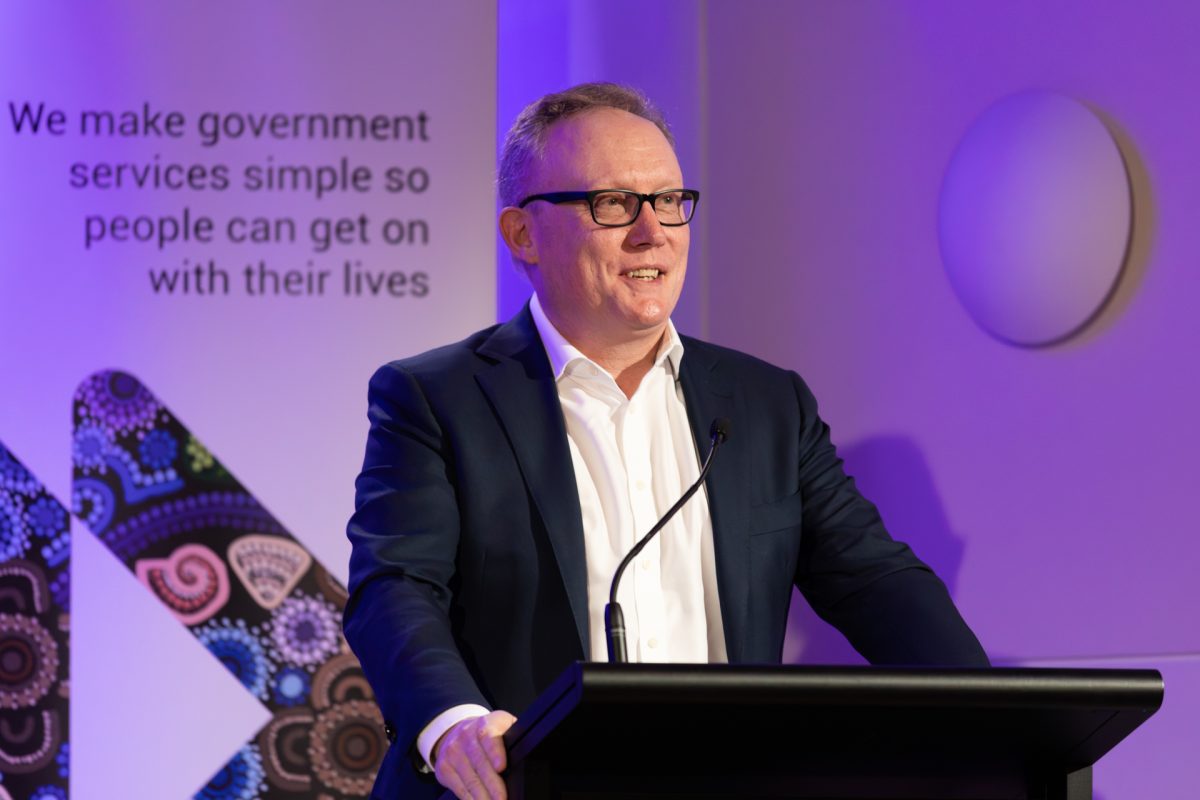 A man speaking at a lectern