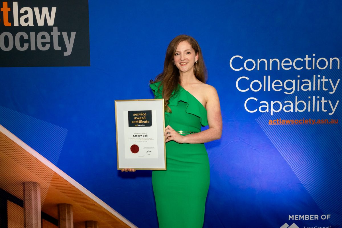 woman holding award certificate