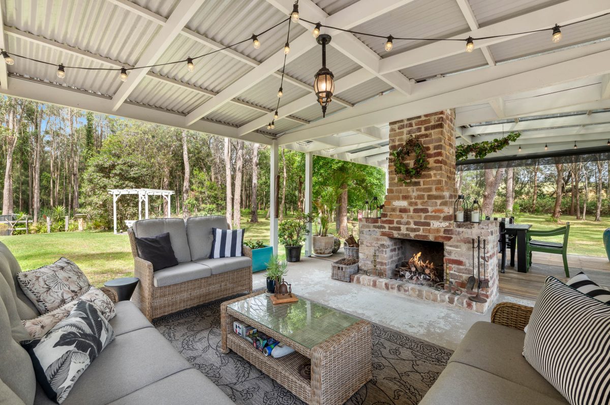 Outdoor entertaining space at 38A Scott Street in Shoalhaven Heads featuring a fireplace