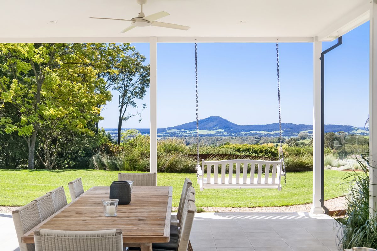 Swinging sweetheart seat overlooking mountains and ocean