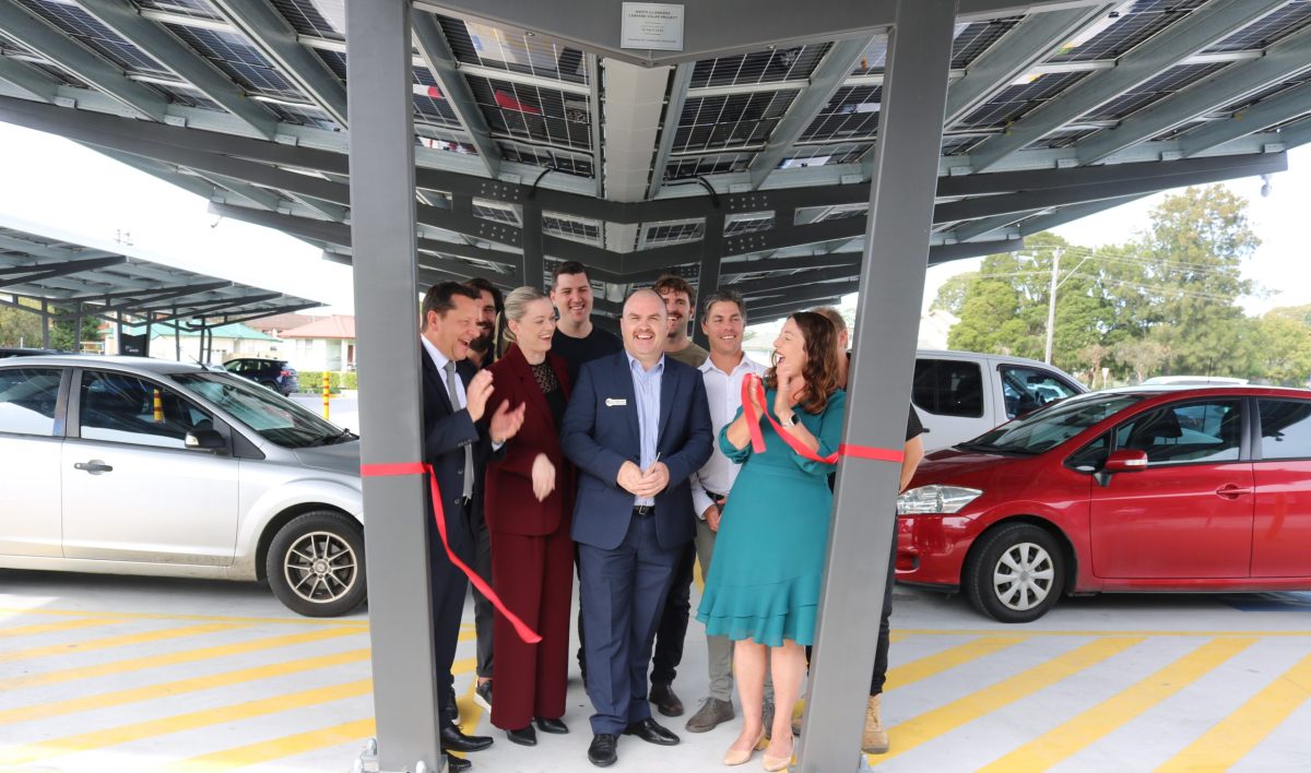 Group of people cutting ribbon