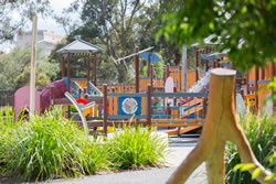 Playground has swing at a food kiosk