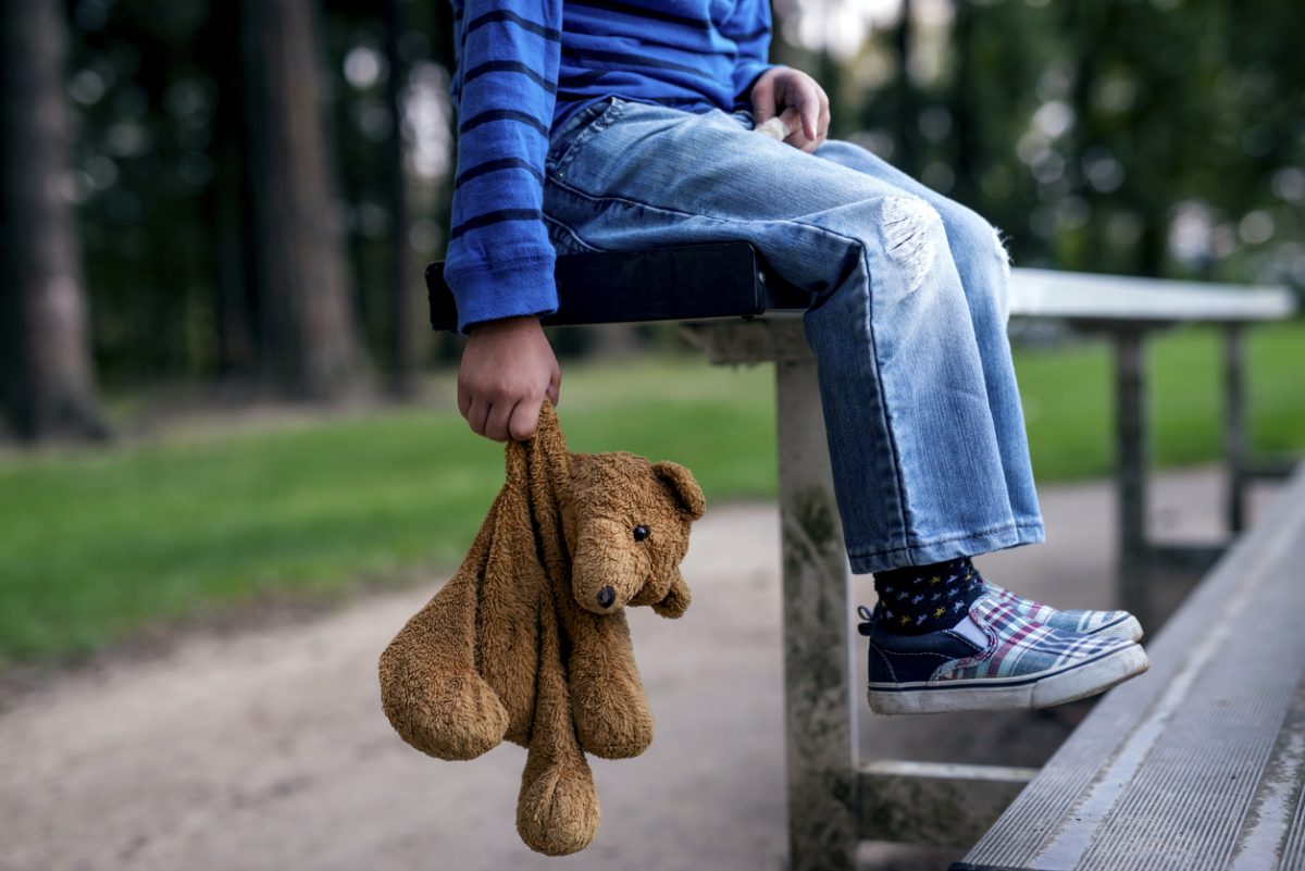 Child holding teddy bear