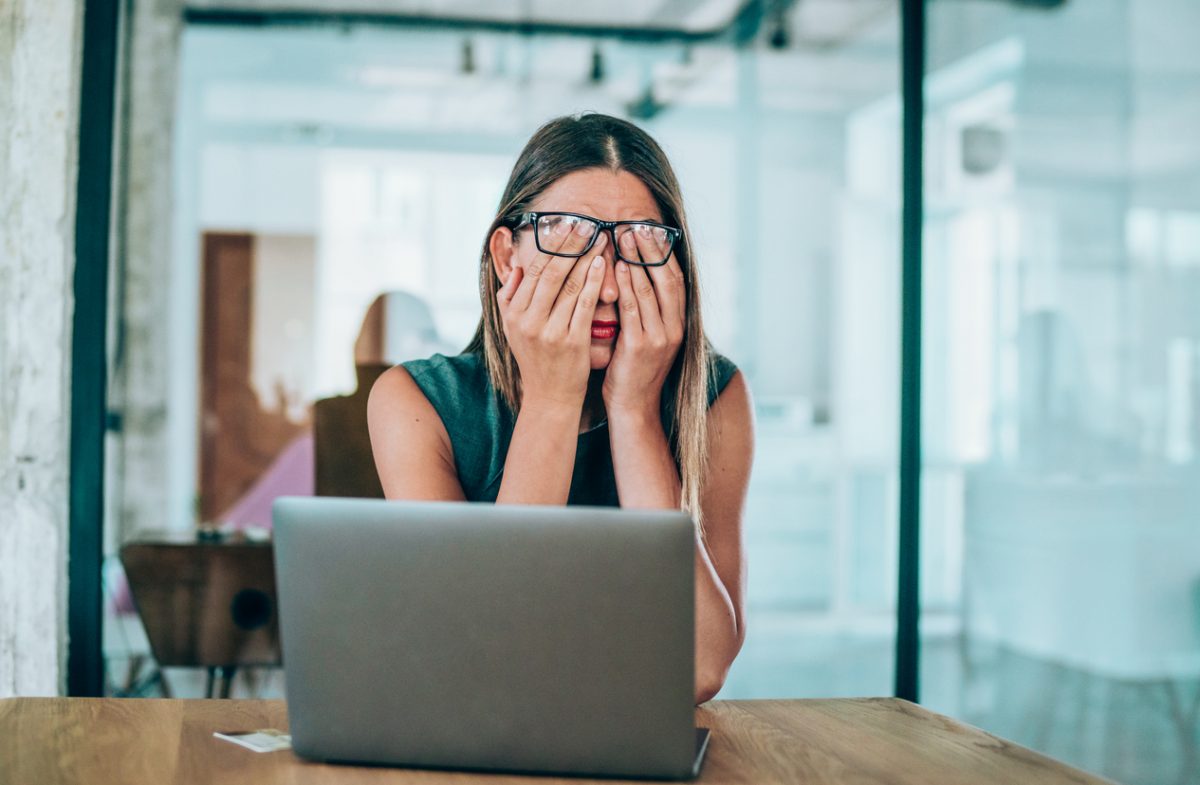 stressed businesswoman with headache in the office