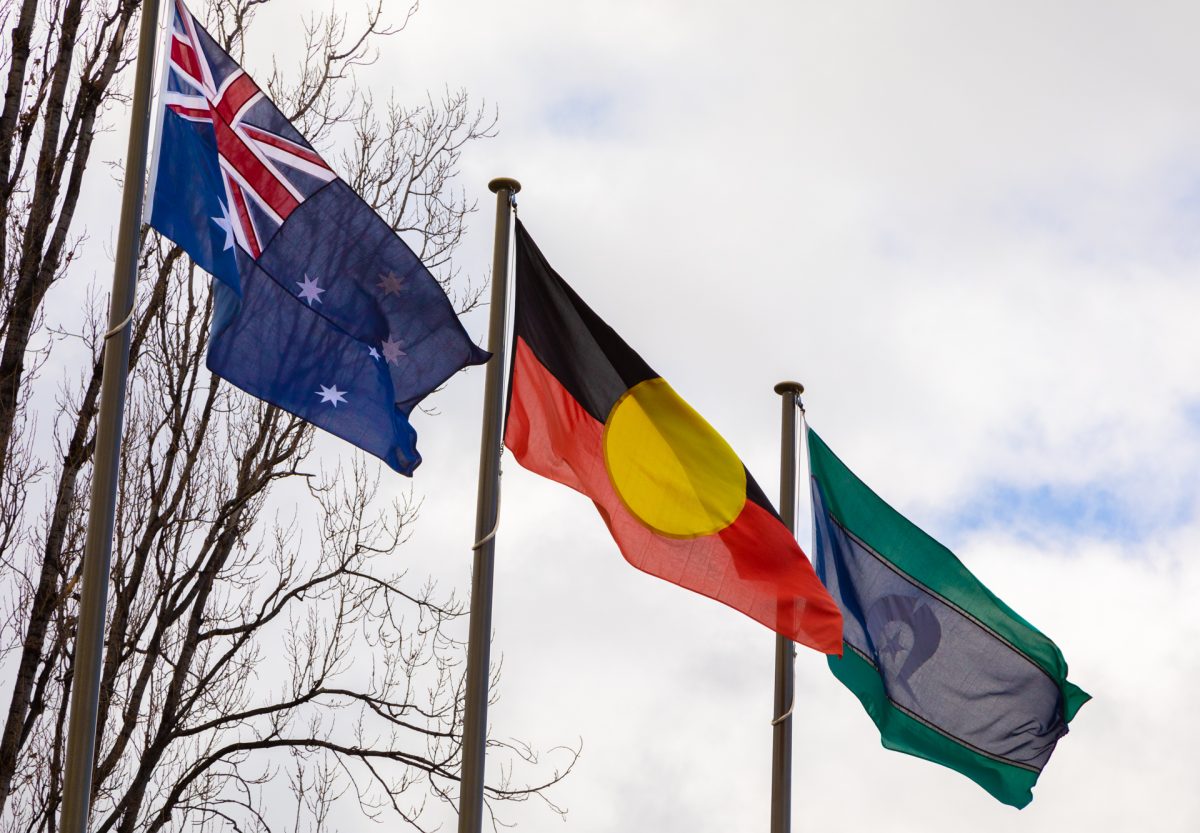 three flags atop poles 