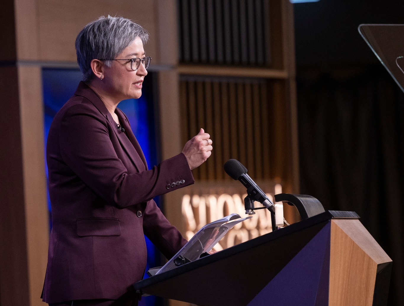 a woman giving a speech at a lectern