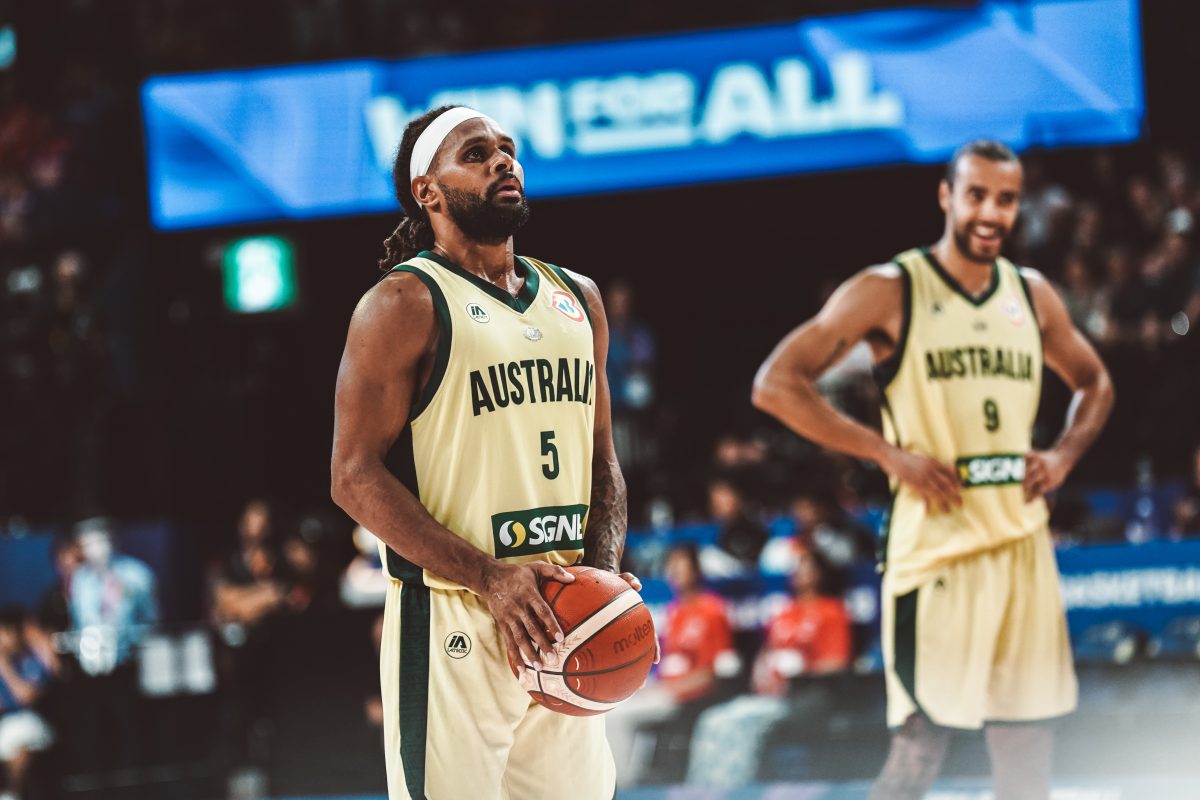 patty Mills wearing a basketball jersey on the court preparing to shoot.