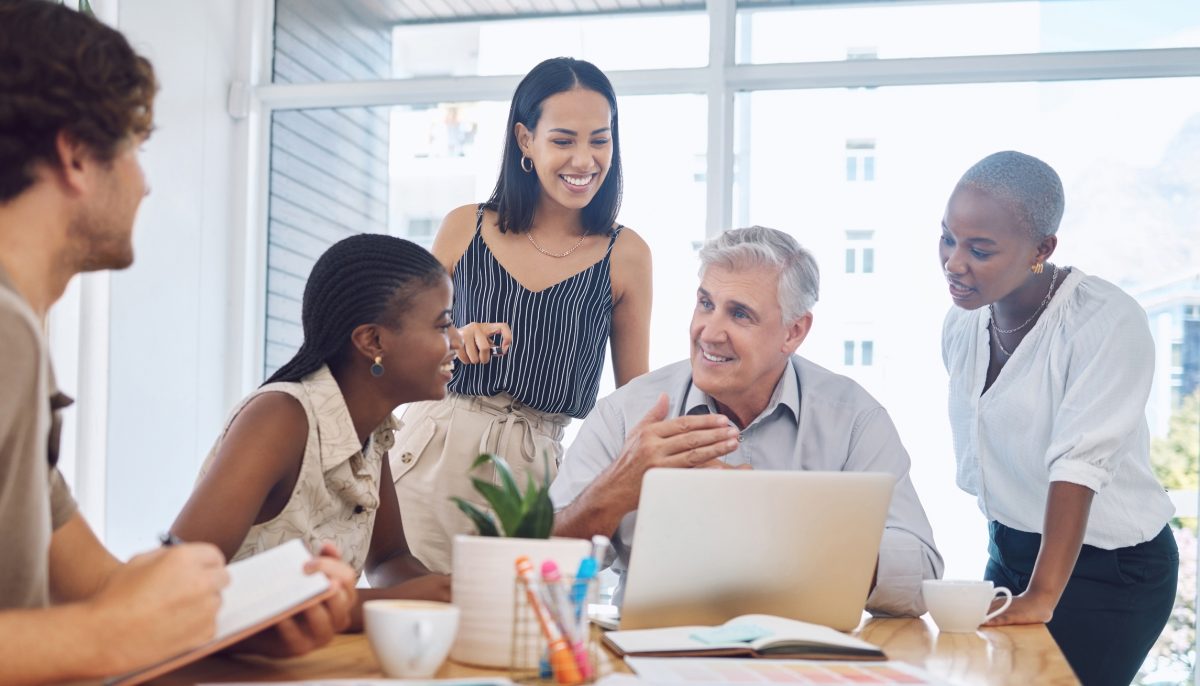 people gathered around an office desk