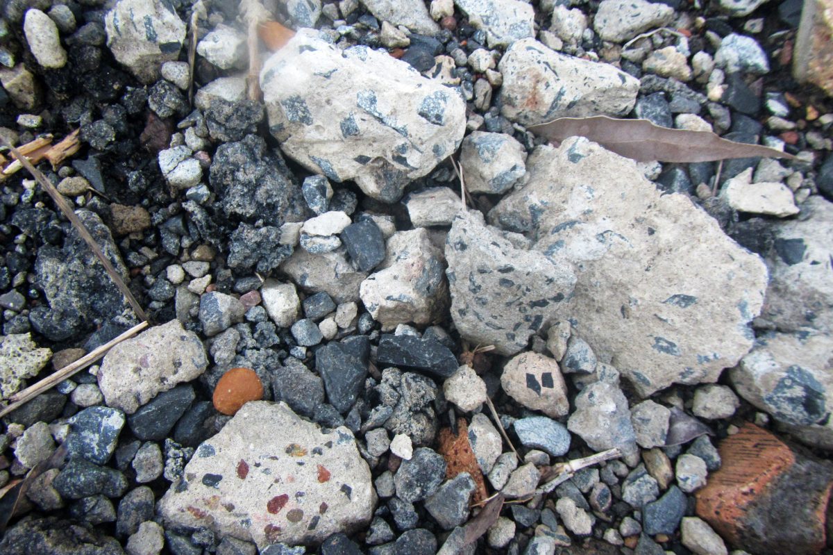 Toxic quarry with heaps of concrete, stones, gravel and asphalt.
