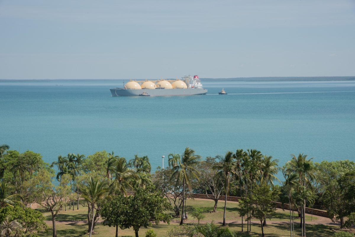 LNG carrier in the Timor Sea with tugboat and view over Bicentennial Park in Darwin in the NT of Australia