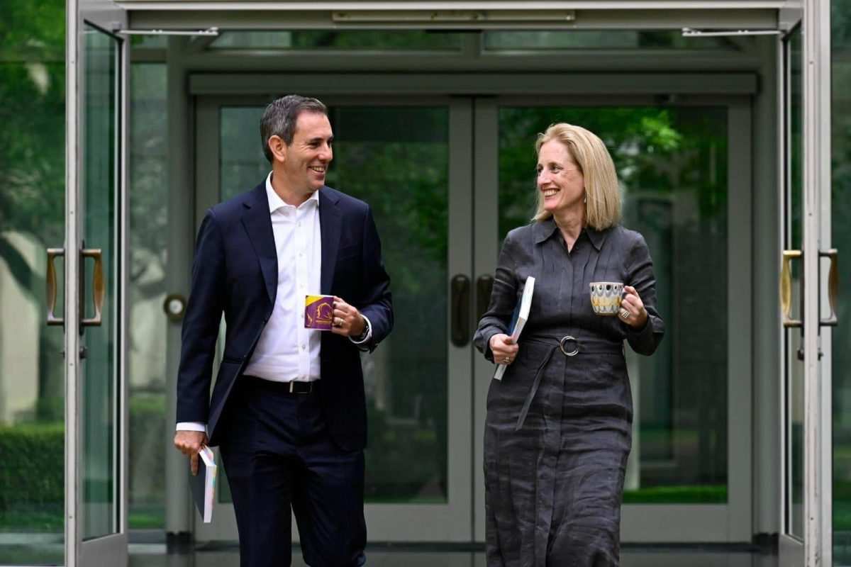 Treasurer Jim Chalmers and Finance Minister Katy Gallagher walking together with coffees in their hands at Parliament House.