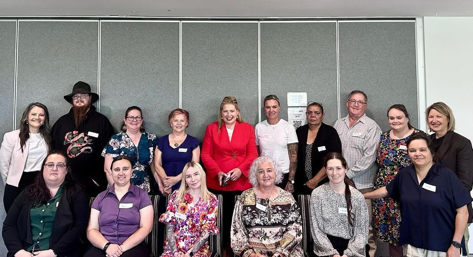 A group of carers and Katrine standing together.