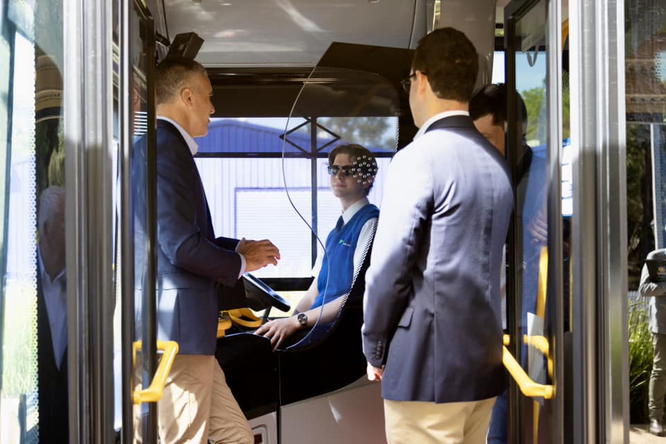 Politicians speaking with drivers in a bus.
