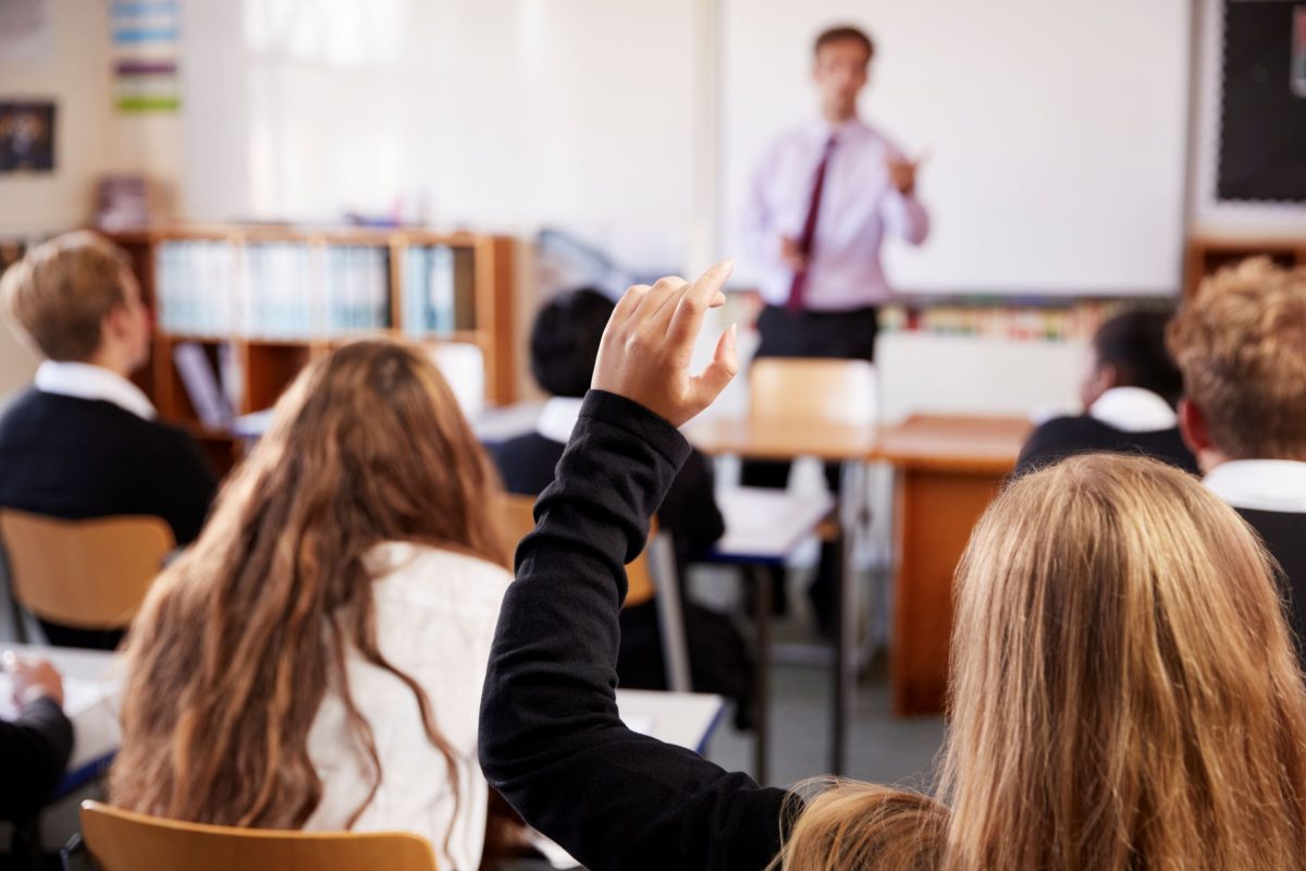 Student asking a question in a classroom