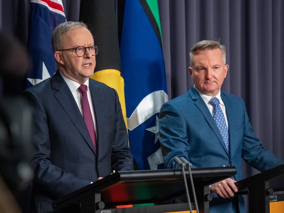 two men in suits at lecterns